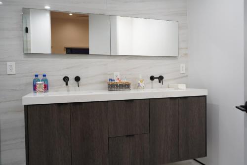 a bathroom with two sinks and a mirror at The Hollywood House in Los Angeles