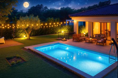 a swimming pool in the yard of a house at night at Villa Destiny Nedescina, Istrien, Kroatien in Nedeščina
