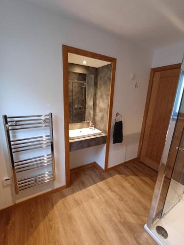 a bathroom with a sink and a mirror at Auld Hoose in Kirkwall