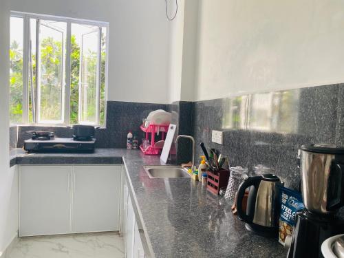 a kitchen with a sink and a counter top at Lavish in Weligama