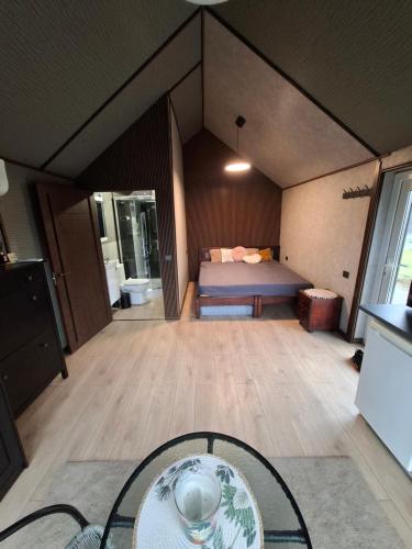 a room with a bed and a glass table at TORA nameliai in Aukštadvaris