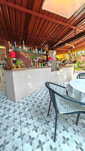 a restaurant with a table and a bar at RELAX ECO Life Center-Khao Lak in Khao Lak