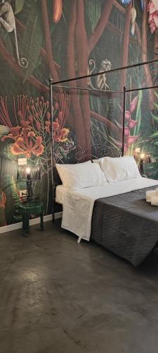 a bedroom with a large bed with a painting on the wall at Tappetà perì in Campobasso