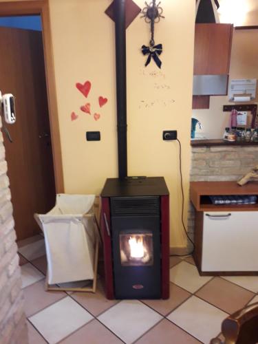 a fireplace in a kitchen with hearts on the wall at Cà Dalilà relax natura e familia in Stancadora