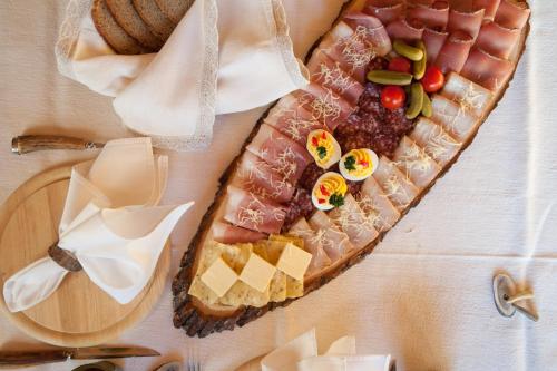 a plate of food with meat and vegetables on a table at Allesbauer - Familie Preis in Trebesing