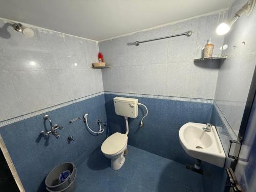 a bathroom with a toilet and a sink at Trippy Turtle in Arambol