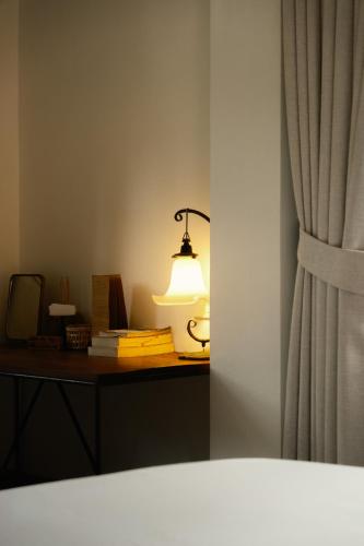 a lamp sitting on a desk next to a curtain at Big Tree Boutique Hotel in Ko Tao