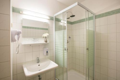 a bathroom with a sink and a shower at Star City Hotel in Budapest