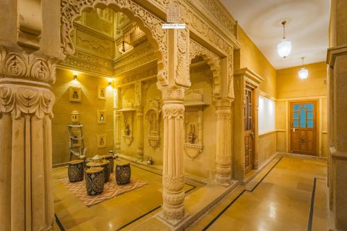 an ornate room with columns in a building at Hotel Rugh Niwas in Jaisalmer