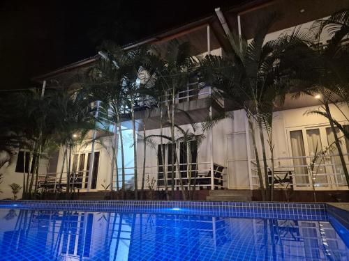 ein Schwimmbad vor einem Gebäude bei Nacht in der Unterkunft La Volga Beach Resort in Chopdem