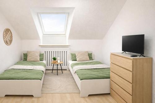 a room with two beds and a television in it at Ferienwohnung MeDa in Bad Wörishofen