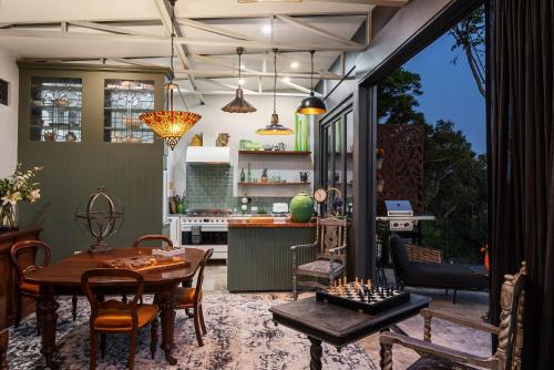 a kitchen and living room with a table and chairs at Escape to Serenity in Beechmont Luxurious Cabin Retreat in Beechmont