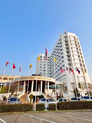 a large building with flags in front of it at Thongtarin Hotel in Surin