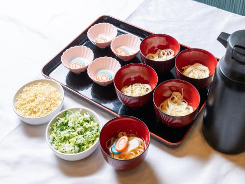 a tray with bowls of food on a table at APA Hotel Uozu Ekimae in Uozu