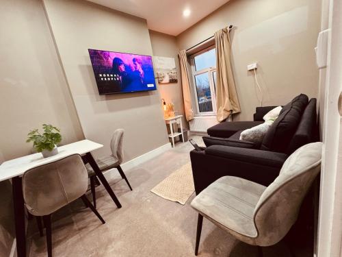 a living room with a couch and a table at Flat in Manchester, 2 en-suite Beds, Etihad, Coop in Manchester