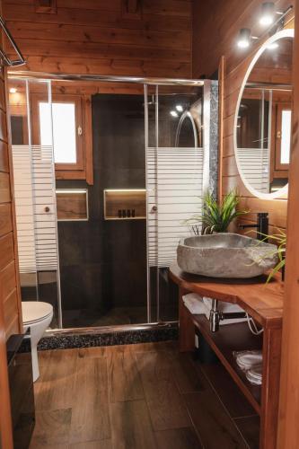 a bathroom with a shower and a sink at Cave Chalet - Chalet for Two in Eptalofos