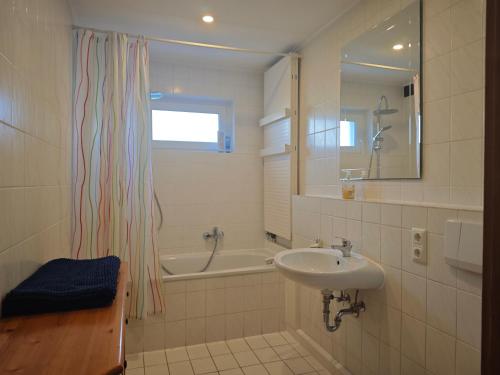 a bathroom with a sink and a bath tub at Apartment in Landsberg, Erpfting in Landsberg am Lech