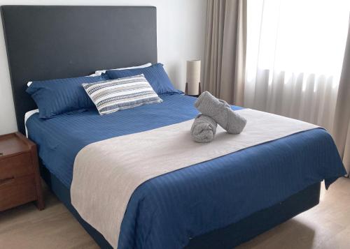 a bed with two stuffed animals sitting on it at City Centre Comfort, Style and Convenience in Brisbane