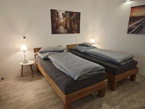 two twin beds in a room with two lamps at Apartment in Landsberg, Erpfting in Landsberg am Lech