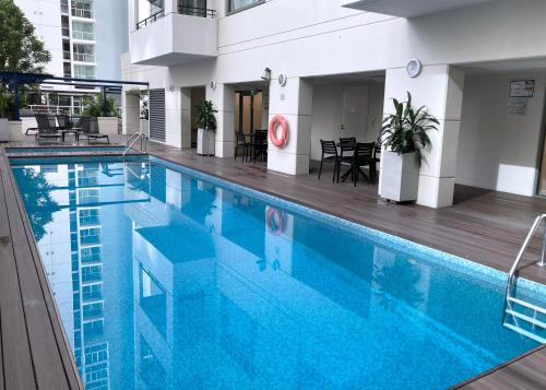 a swimming pool with blue water in a building at City Centre Comfort, Style and Convenience in Brisbane