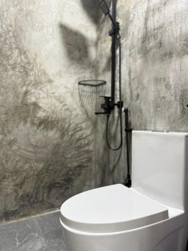 a bathroom with a toilet and a shower at Reinforce Residence in Thulusdhoo