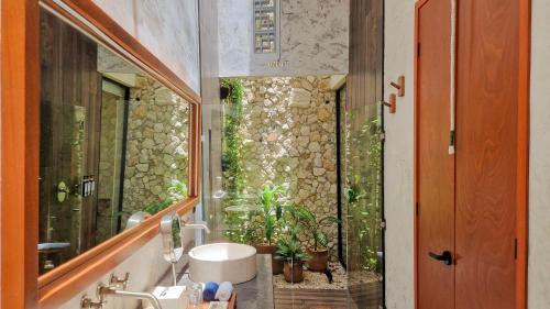 a bathroom with a sink and a mirror at Casa María Eulalio - Boutique Guesthouse in Mérida