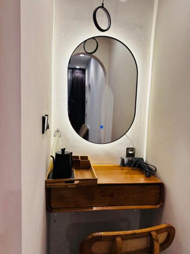 a bathroom with a mirror and a wooden vanity at Pinggan Tavora in Gretek