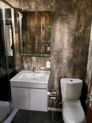 a bathroom with a white sink and a toilet at Tres de Mayo in San Luis