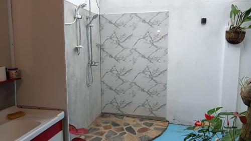 a shower with a glass door in a bathroom at Aqua Vista Studio Appartment in Tangalle