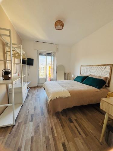 a bedroom with a large bed and a wooden floor at NEW Brenta 10 minutes To Duomo M3-15 minutes to Linate - Full furnished APT with AC, Wi-fi and more in Milan