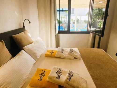 a bedroom with a bed with two pillows on it at Villa Vista with heated pool & Jacuzzi in Playa Blanca
