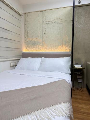 a bedroom with a bed with a large headboard at The UrbanNest - 1BR Condo in Marina Spatial, Dumaguete with free fast WiFi and Pool in Piapi