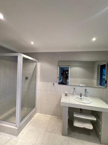 a bathroom with a sink and a shower at Bonza Bay Bliss in East London