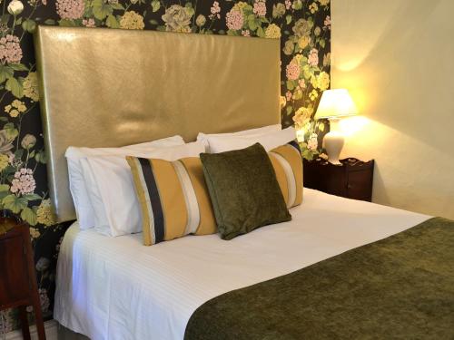 a bedroom with a bed with white sheets and pillows at The Speech House in Coleford