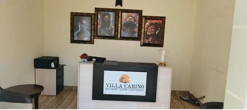 a television in a room with pictures on the wall at Villa Carino Kilifi Kenya in Kilifi