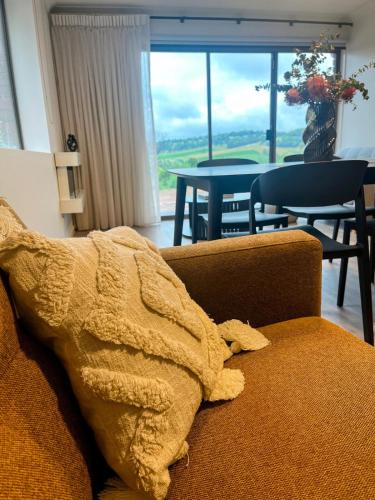 a blanket sitting on a couch in a living room at Honeycomb Hill of Yarra Valley in Steels Creek