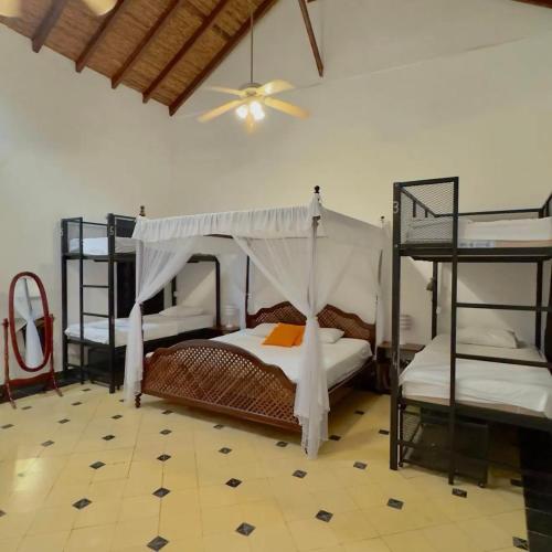 a bedroom with three bunk beds and a ceiling fan at Encuentros in Granada