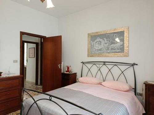 a bedroom with a bed with two pink pillows at La Villetta in Vittorito