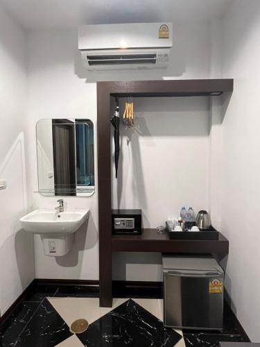 a bathroom with a sink and a mirror and a sink at The CHESS Samui in Chaweng