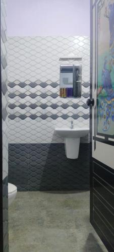 a bathroom with a sink and a toilet at Grape Garden in Varkala