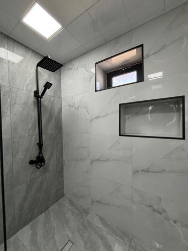 a bathroom with a shower with a glass door at Shahdag Mountain Breeze in Qusar