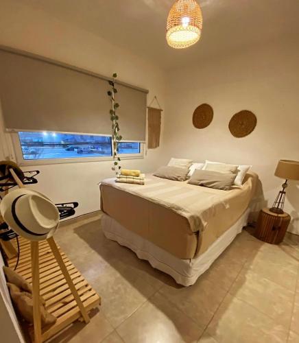 En eller flere senge i et værelse på La Félicité Alojamiento