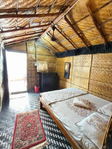 a bedroom with a large bed in a room at Hampi's Dream Cottage in Hampi