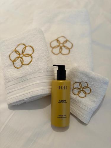 a bottle of soap next to towels and a bottle of shampoo at Ground floor sea view Raversijde Lets Go Getaways in Ostend