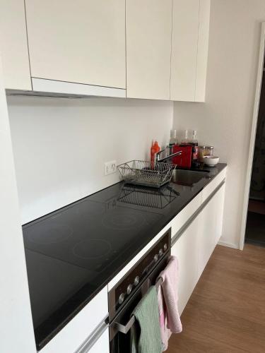 a kitchen with a black stove top oven at Fribourg Home in Fribourg