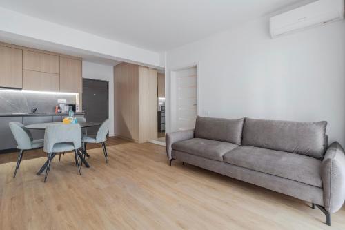 a living room with a couch and a table at Velour Suites in Oradea