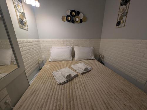una camera da letto con un letto con asciugamani sopra di EV Apartment with free parking place a Volos