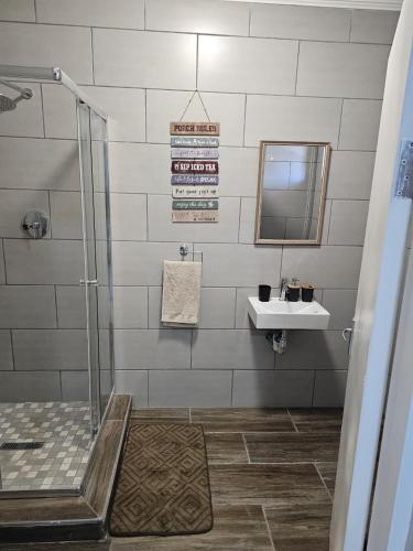 a bathroom with a shower and a sink at Phozi Inn in Eshowe