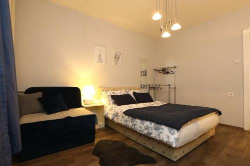 a bedroom with two beds and a couch in it at DARA Apatman in Šabac