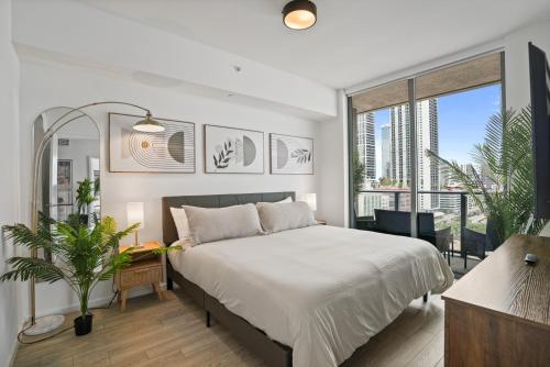 a bedroom with a bed and a large window at Cadenza Miami - Luxury Residences in Miami